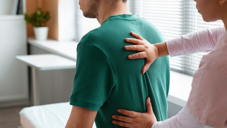 doctor-helping-patient-during-rehabilitation
